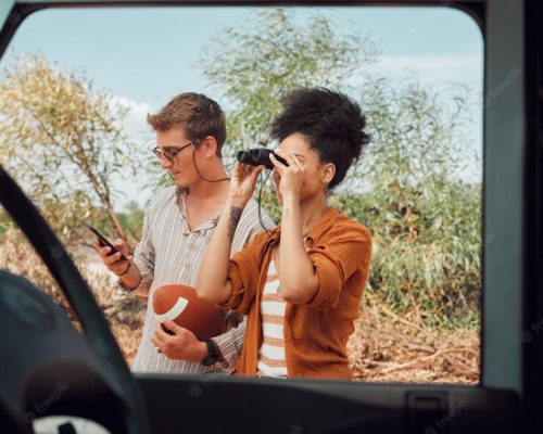 window-car-diversity-couple-road-trip-journey-explore-australia-safari-countryside-outdoor-nature-binocular-transportation-adventure-man-streaming-football-game-mobile-phone_590464-90016.jpg